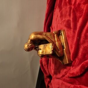 One half of bronze book end
